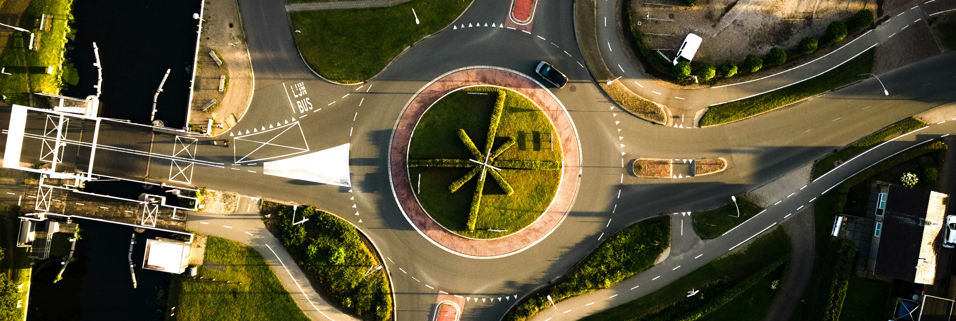 Aerial view of a European road junction and surrounding green spaces